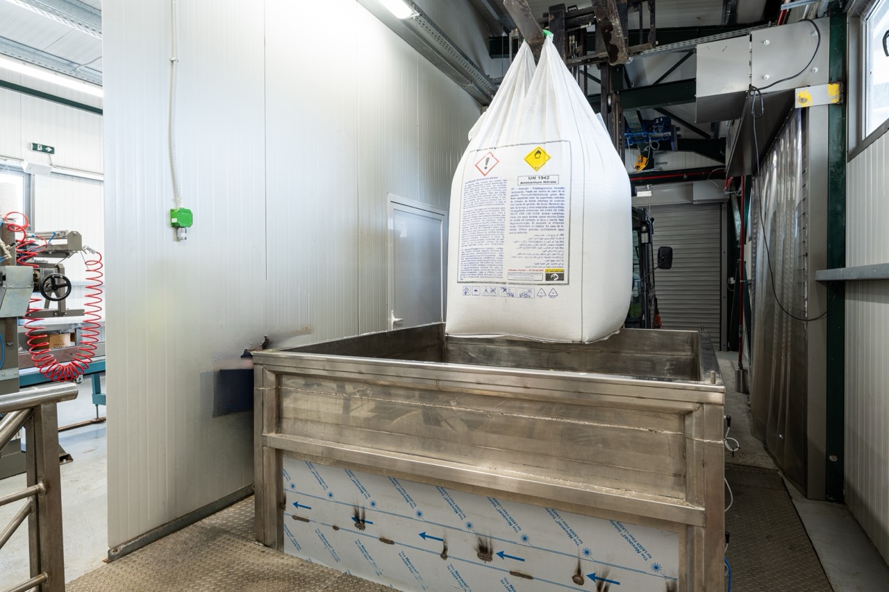 ELTEK operator in hi-vis vest and safety glasses in the raw material feeding area