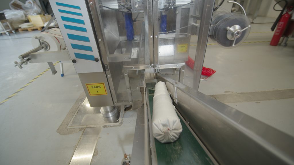 Sealed cartridge on the conveyor of ELTEK's chub packaging unit